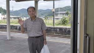 Elderly Man Waving at Rural Station preview