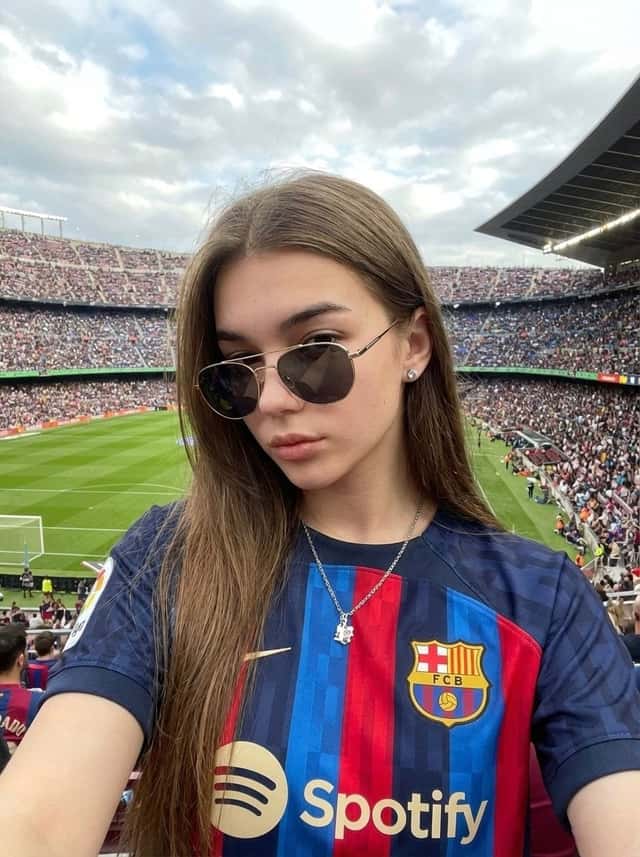 Realistic, selfie-style photo of a woman wearing a Barcelona jersey preview