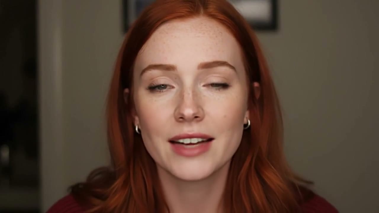 Red-haired woman speaking to camera