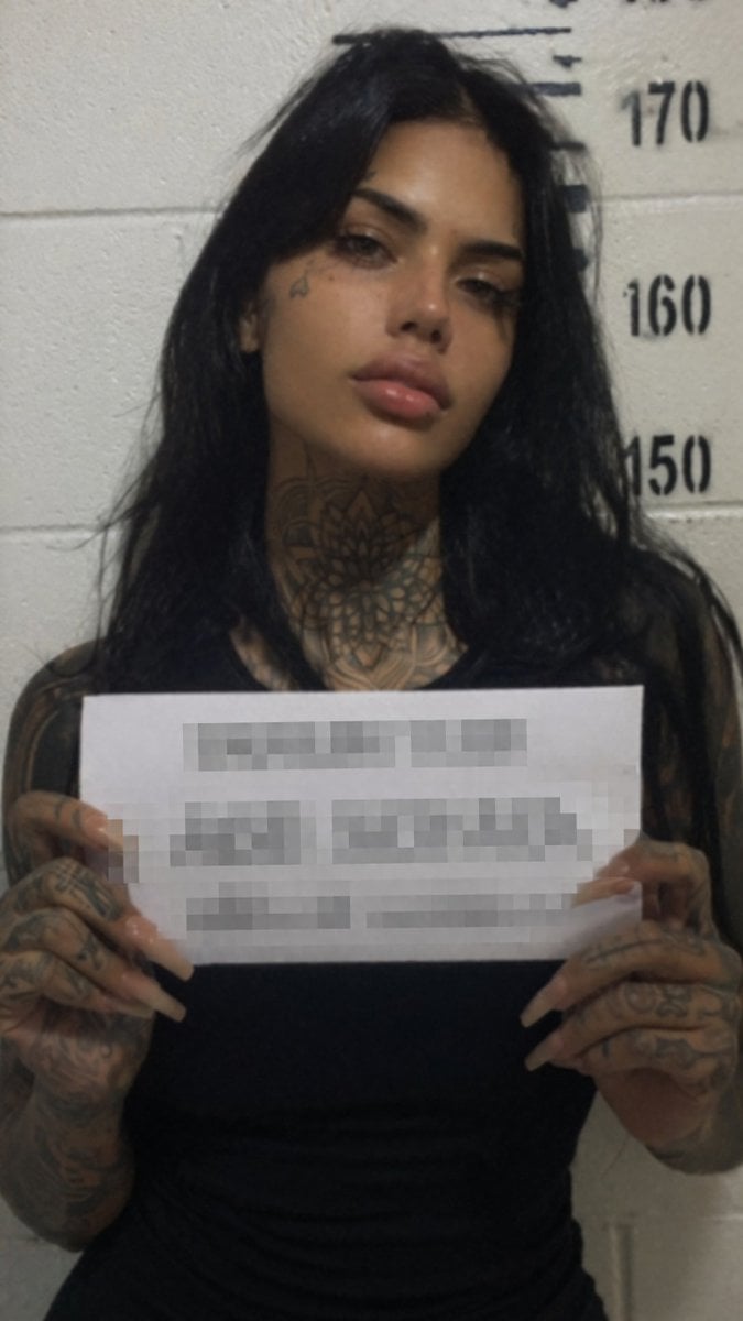 Gritty Tattooed Woman Mugshot