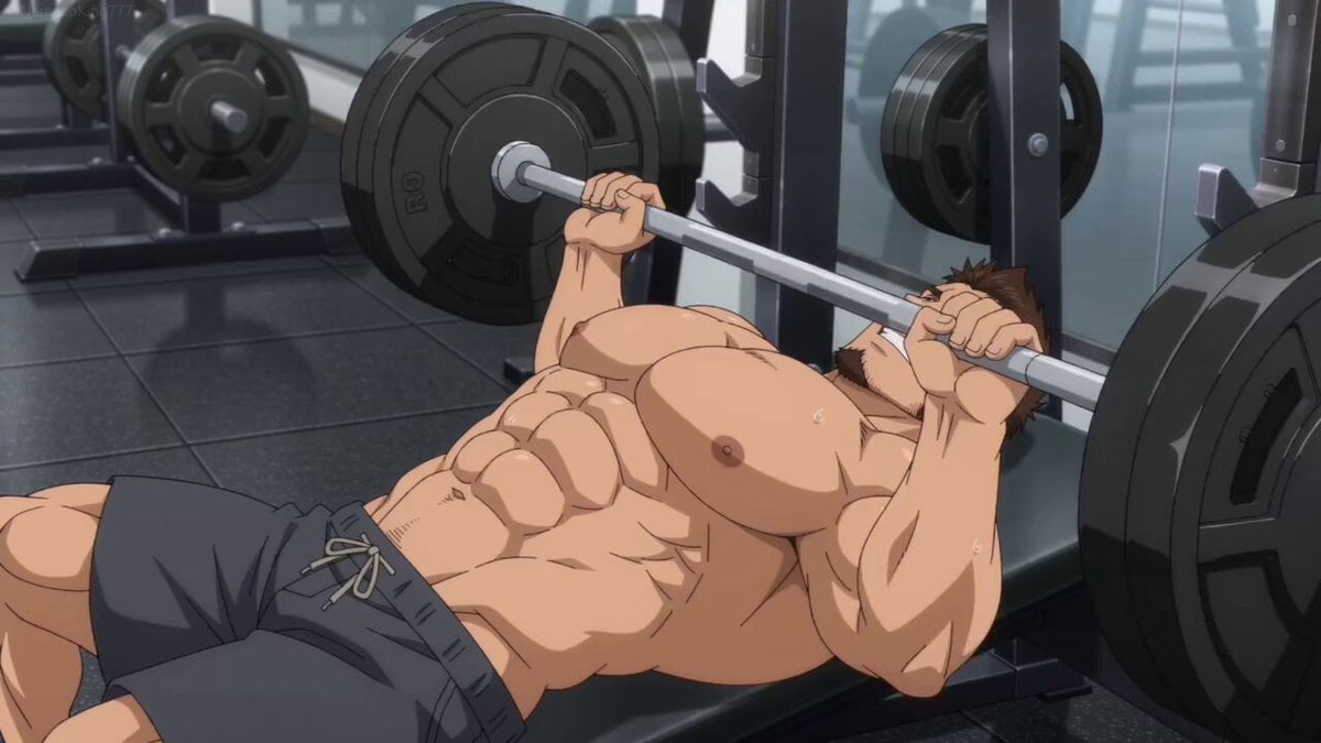 Muscular Man Bench Pressing in Gym
