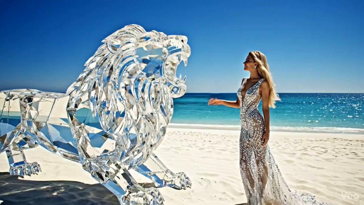 Huge diamond-like lion roaring on a white beach with an elegant woman