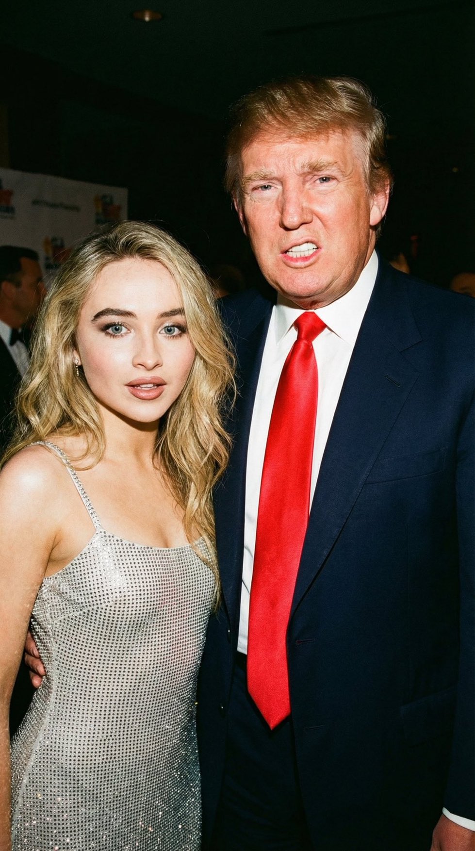 A candid photograph from the 1990s of Donald Trump in a dark suit