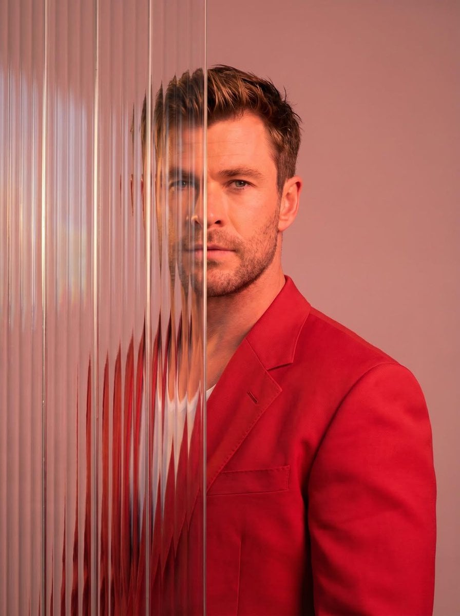 A striking editorial portrait photograph of a person wearing a red