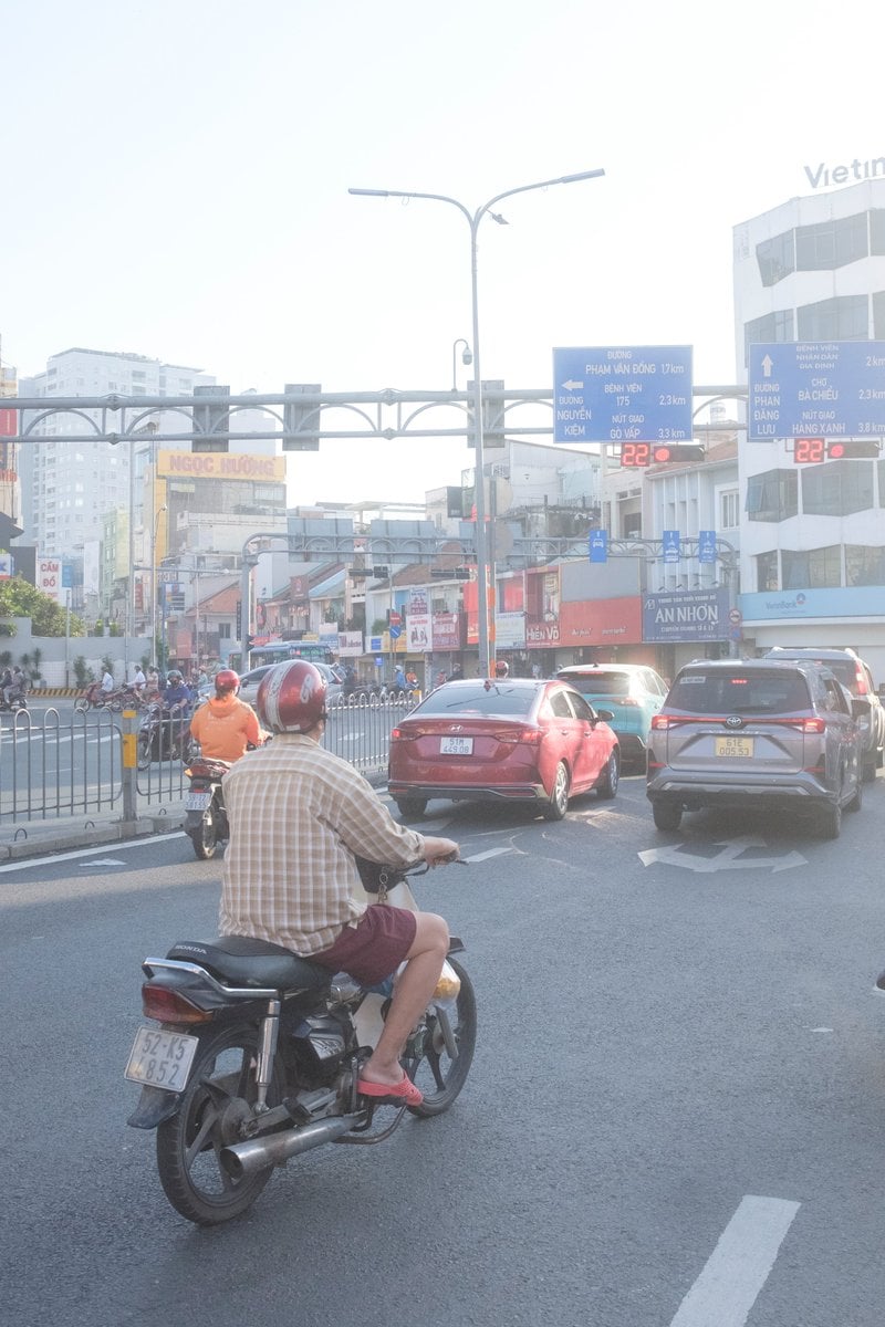Edit city photo into rainy scene with Vietnamese bikers
