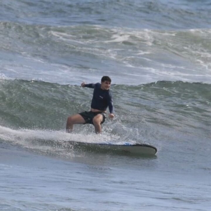 Grok Imagine prompt: Surfer riding a pipeline wave
